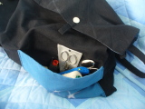 A front pocket with scissors, thread, etc.