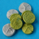 small pile of silver and green coins